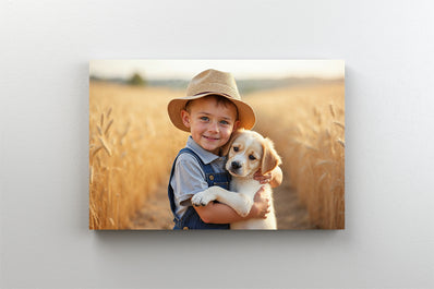 Tablou Canvas - Baietel cu un catelus in brate in campul de grau